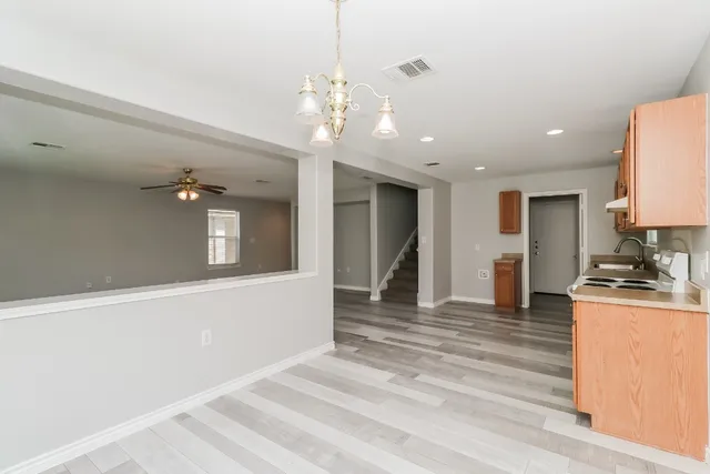 a view of a room with a ceiling fan and a ceiling fan