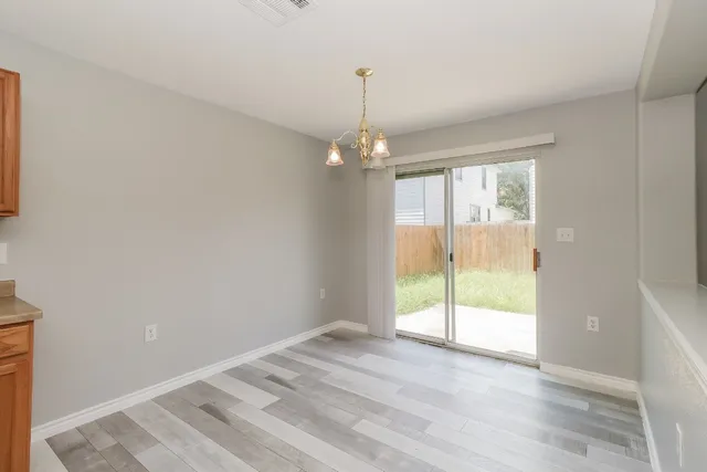 a view of a kitchen with a sink and a refrigerator
