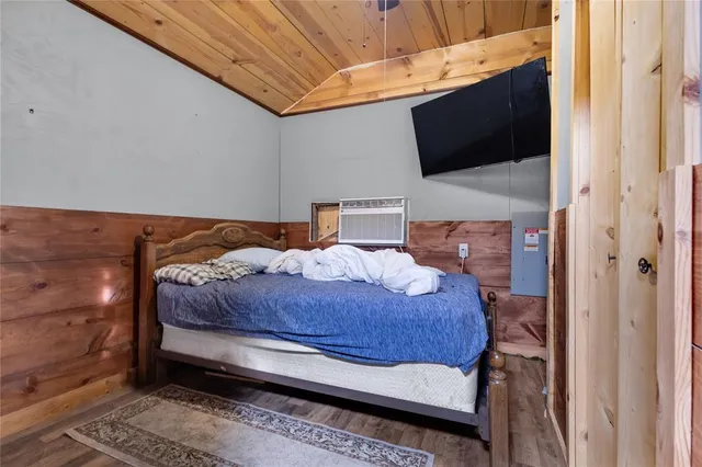 a bedroom with a bed and flat screen tv