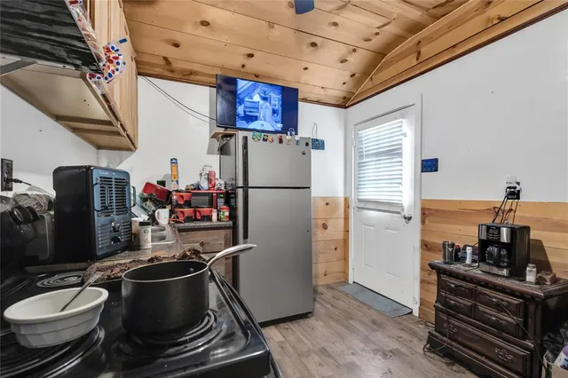a kitchen with stainless steel appliances granite countertop a refrigerator and a stove