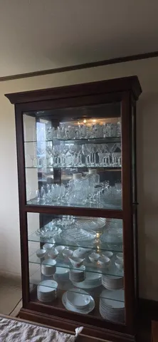 a bedroom with a bed and a dresser with wooden floor