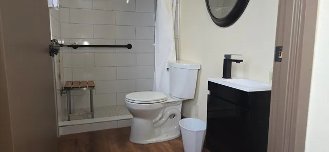 a living room with furniture and wooden floor