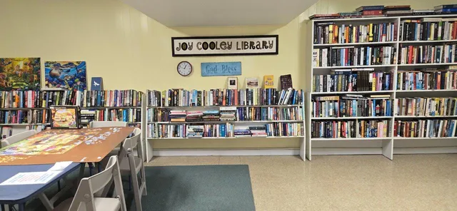 a kitchen with a dining table chairs and white cabinets