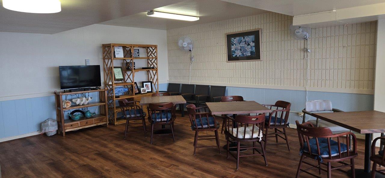 84 Pukihae Street, Unit PH6 Hilo, HI 96720 - Photo 27 of 29 a view of a dining room with furniture and wooden floor