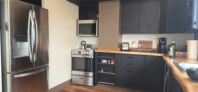a kitchen with stainless steel appliances granite countertop a refrigerator and a sink