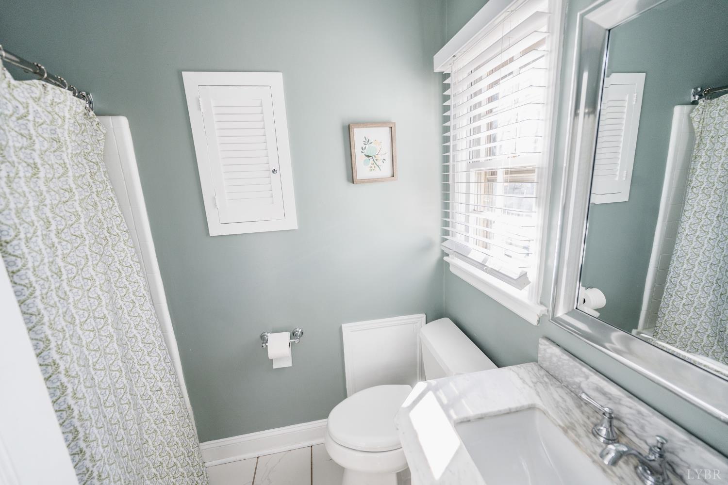 5152 Wedgewood Road Lynchburg, VA 24503 - Photo 24 of 70 a white toilet sitting next to a bathroom sink and tub