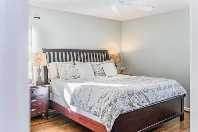 a bedroom with a bed and a large window with the outer view