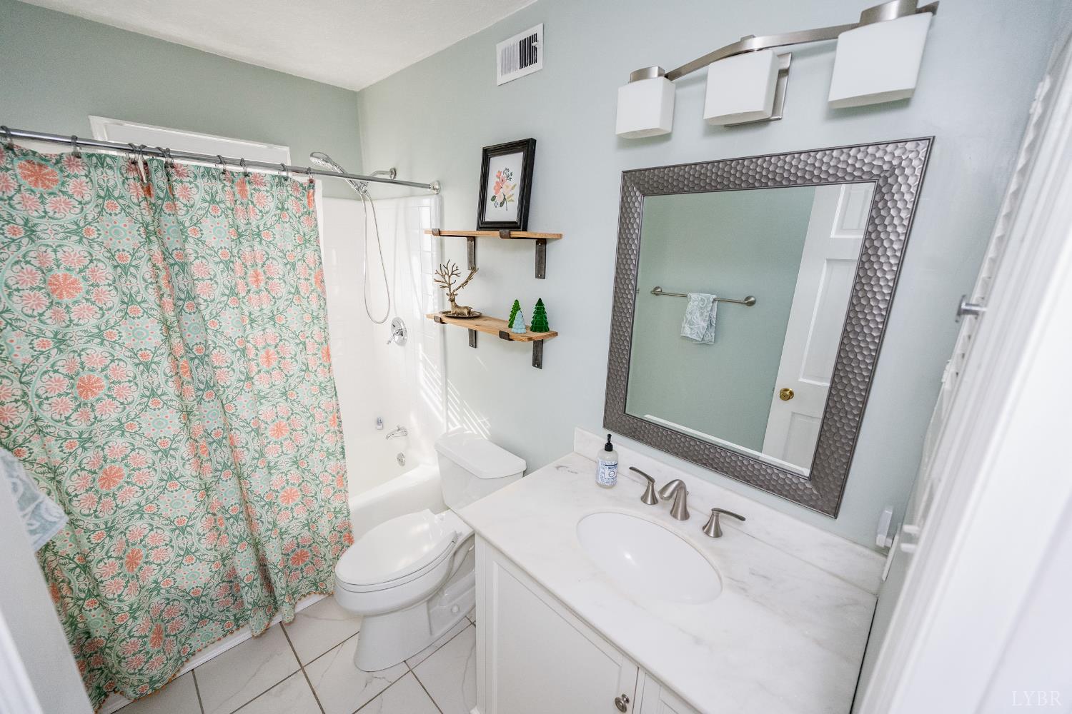 5152 Wedgewood Road Lynchburg, VA 24503 - Photo 26 of 70 a bathroom with a sink a toilet and shower curtain