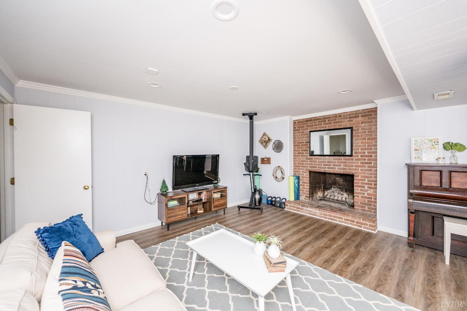 5152 Wedgewood Road Lynchburg, VA 24503 - Photo 32 of 70 a living room with furniture flat screen tv and a fireplace