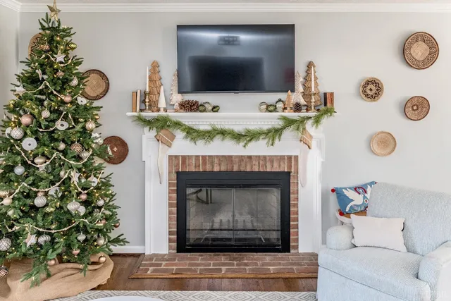 a living room with furniture a fireplace and a flat screen tv