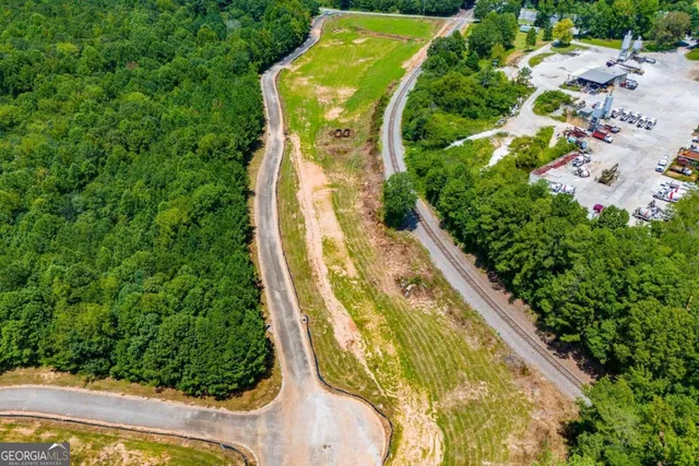 an aerial view of a residential houses with yard