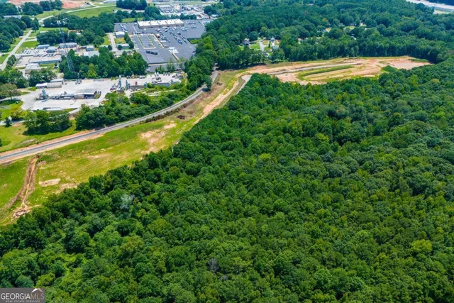 an aerial view of residential houses with outdoor space and street view