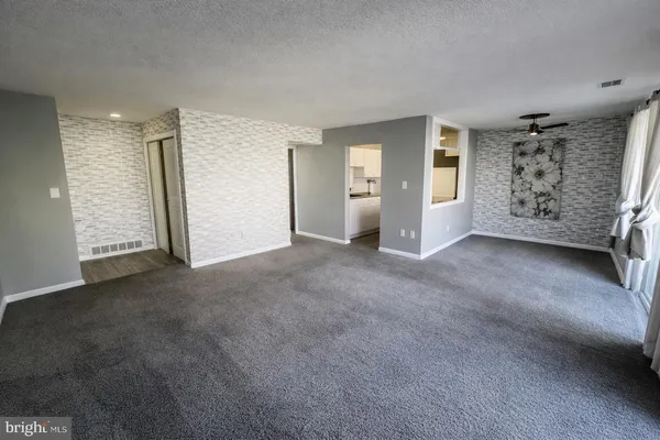 an empty room with windows and closet