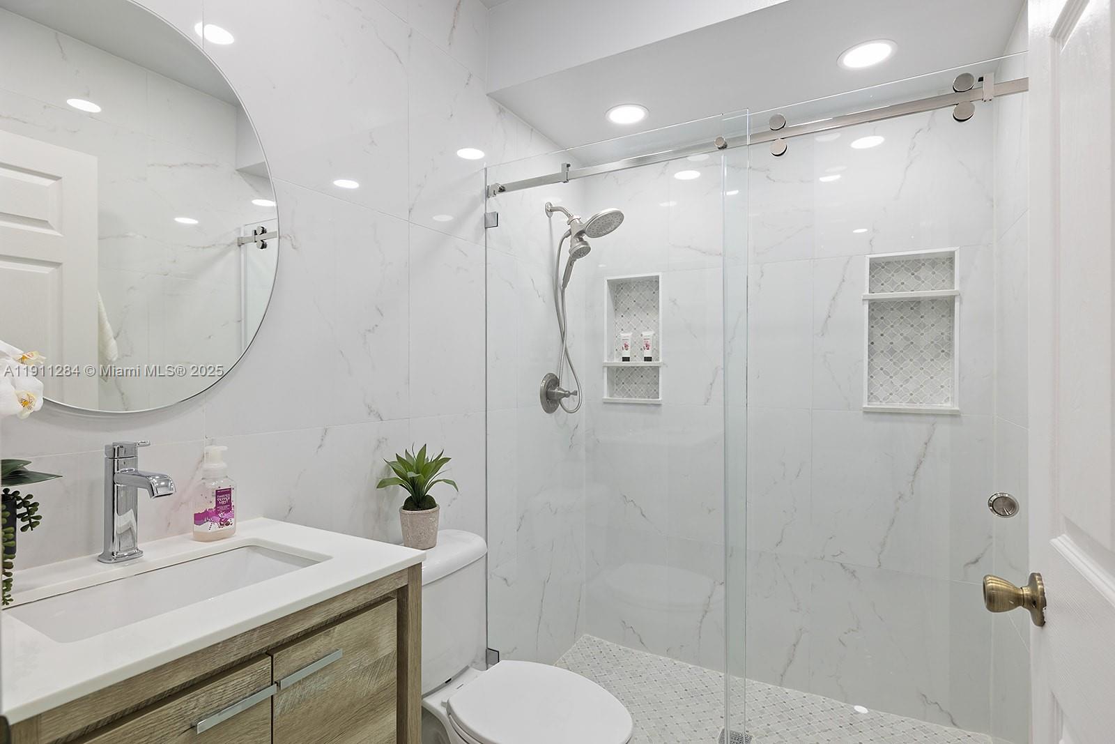 16296 Southwest 26th Street Miramar, FL 33027 - Photo 17 of 48 a bathroom with a sink toilet and shower