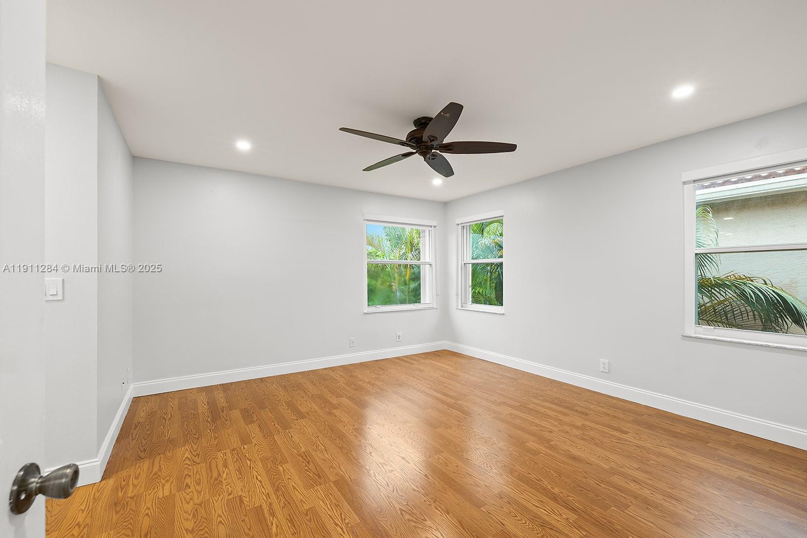 16296 Southwest 26th Street Miramar, FL 33027 - Photo 20 of 48 a view of empty room with wooden floor and fan