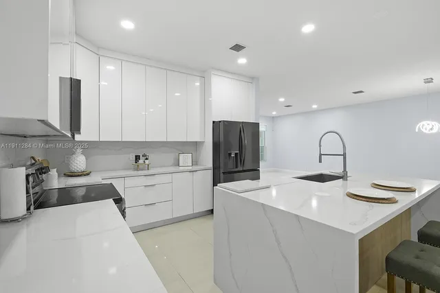 a kitchen with a sink stainless steel appliances and cabinets