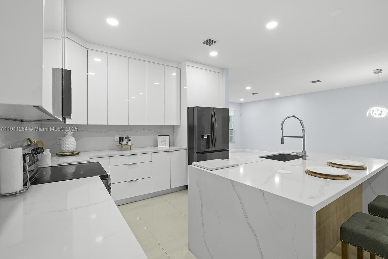 16296 Southwest 26th Street Miramar, FL 33027 - Photo 2 of 48 a kitchen with a sink stainless steel appliances and cabinets