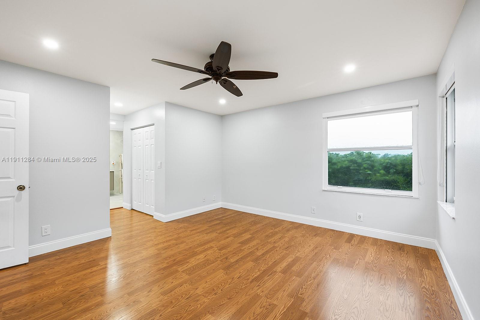 16296 Southwest 26th Street Miramar, FL 33027 - Photo 23 of 48 a view of an empty room with wooden floor and a window