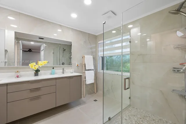 a bathroom with a double vanity sink window and mirror