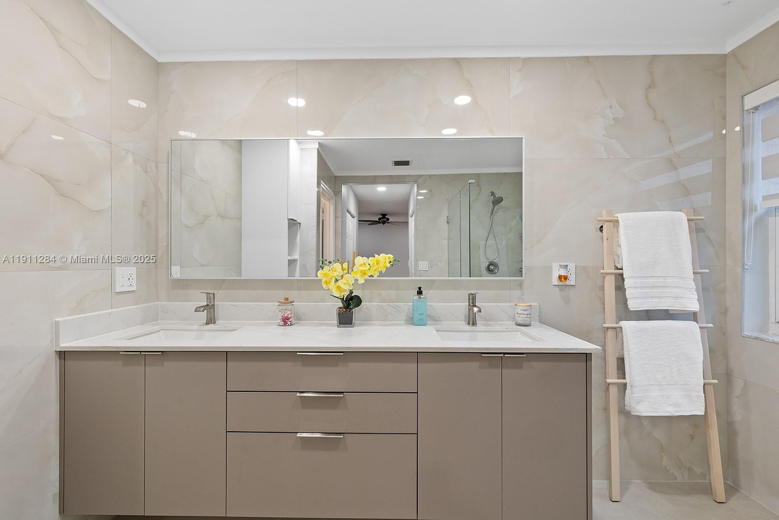 16296 Southwest 26th Street Miramar, FL 33027 - Photo 26 of 48 a bathroom with a double vanity sink mirror and double