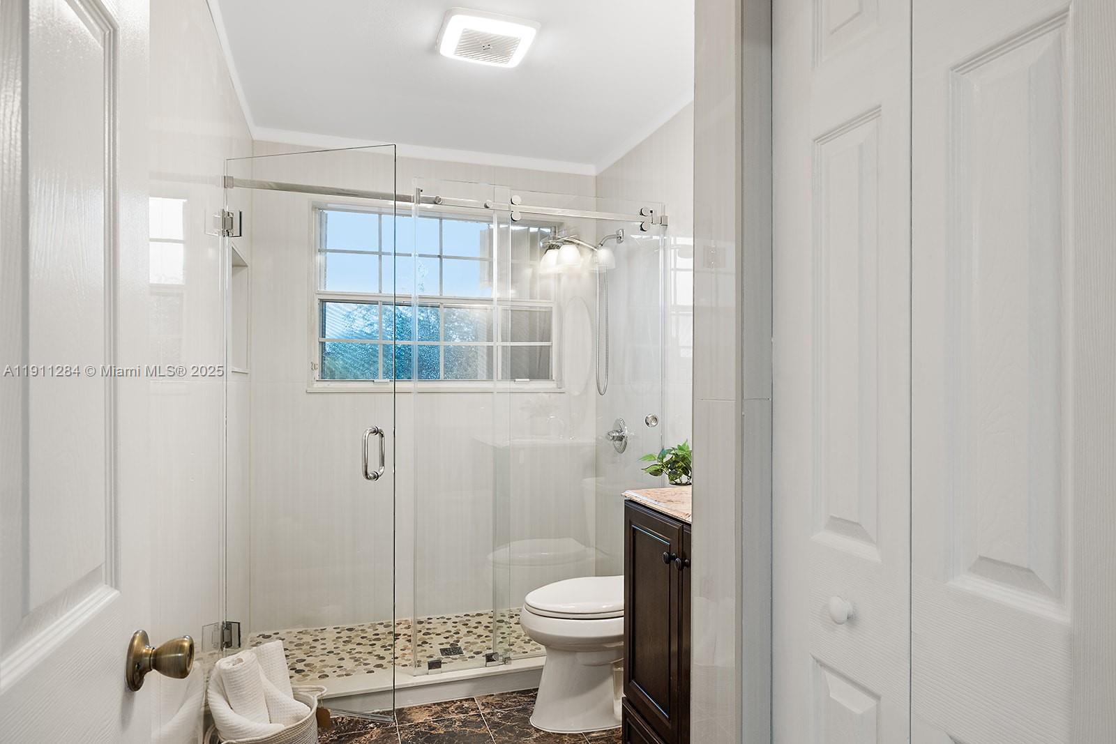 16296 Southwest 26th Street Miramar, FL 33027 - Photo 29 of 48 a bathroom with a toilet a sink and shower