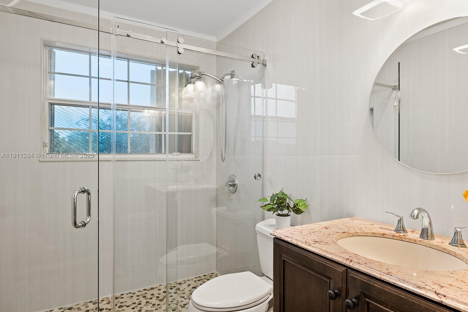 16296 Southwest 26th Street Miramar, FL 33027 - Photo 30 of 48 a bathroom with a granite countertop sink toilet and shower