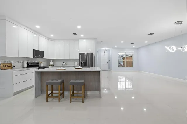 a kitchen with a refrigerator and a microwave