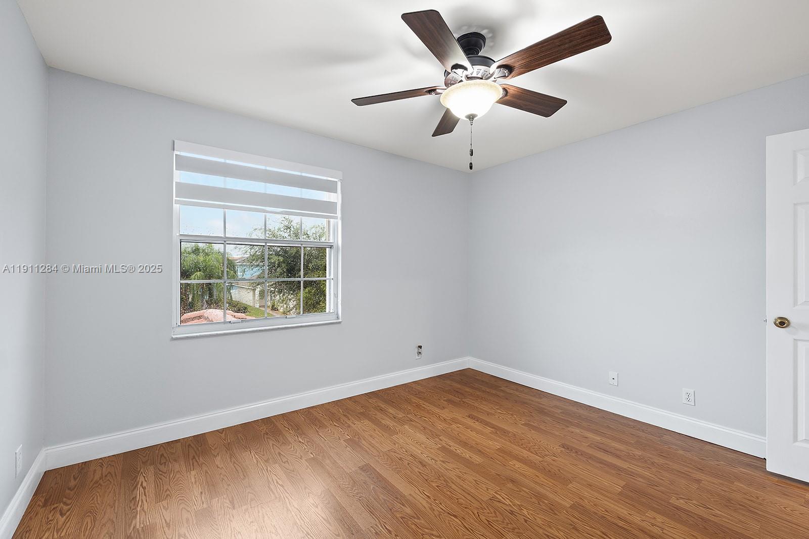 16296 Southwest 26th Street Miramar, FL 33027 - Photo 34 of 48 an empty room with wooden floor and windows