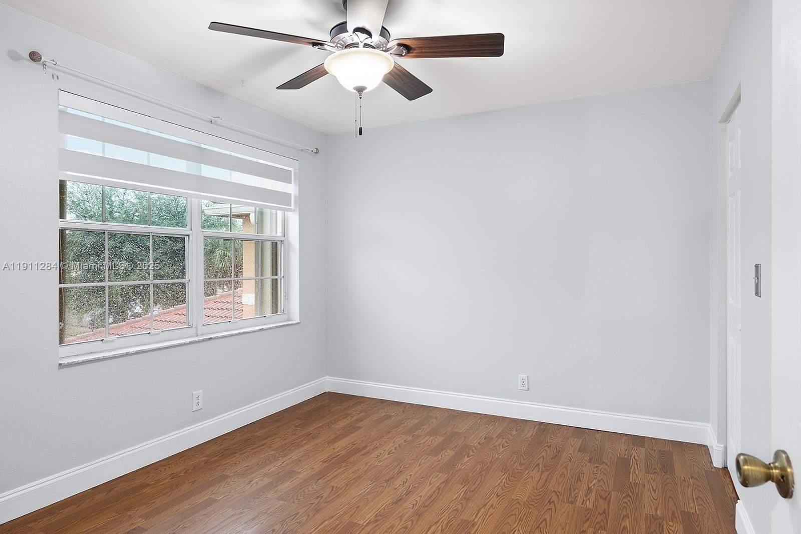 16296 Southwest 26th Street Miramar, FL 33027 - Photo 35 of 48 an empty room with a window and wooden floor