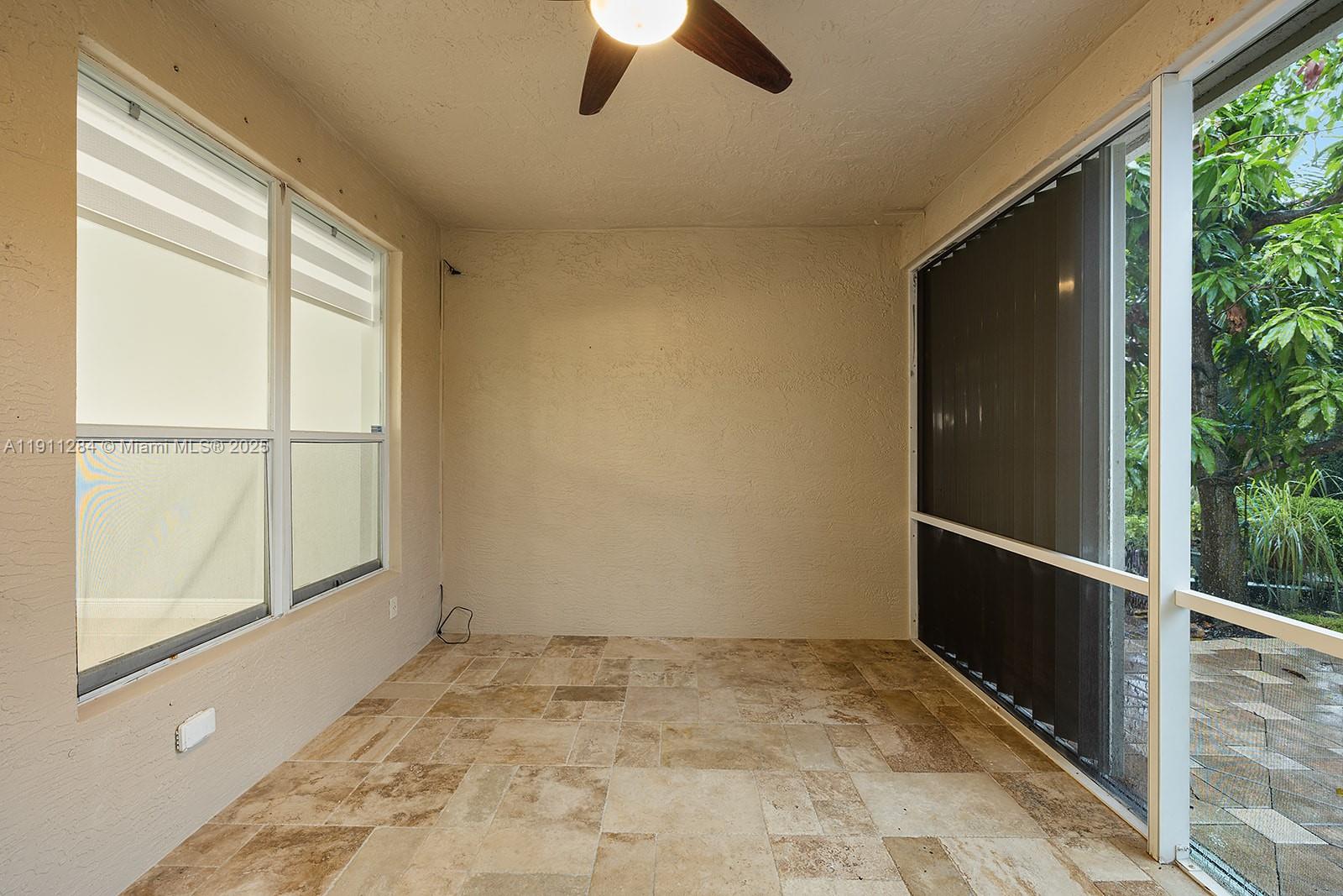 16296 Southwest 26th Street Miramar, FL 33027 - Photo 43 of 48 a view of a livingroom with a ceiling fan and window