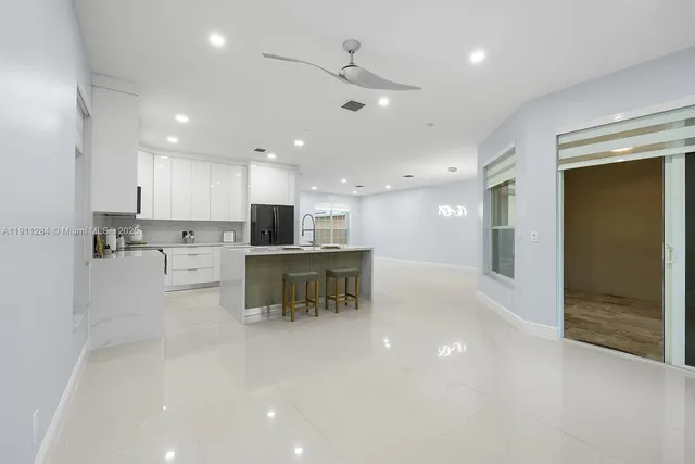 a view of kitchen with kitchen island and stainless steel appliances