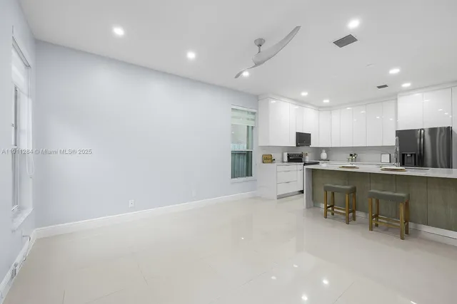 a kitchen with a refrigerator and a sink