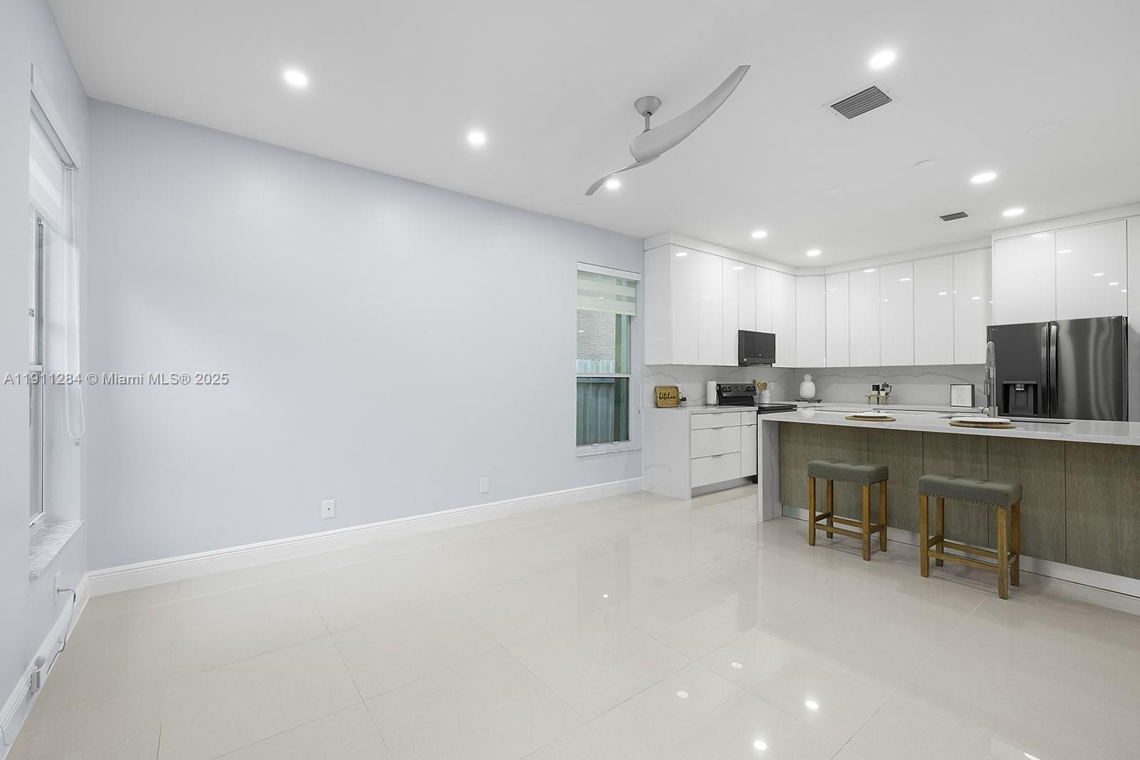 16296 Southwest 26th Street Miramar, FL 33027 - Photo 6 of 48 a kitchen with a refrigerator and a sink