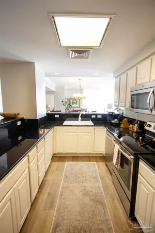 a large kitchen with stainless steel appliances and a large counter top