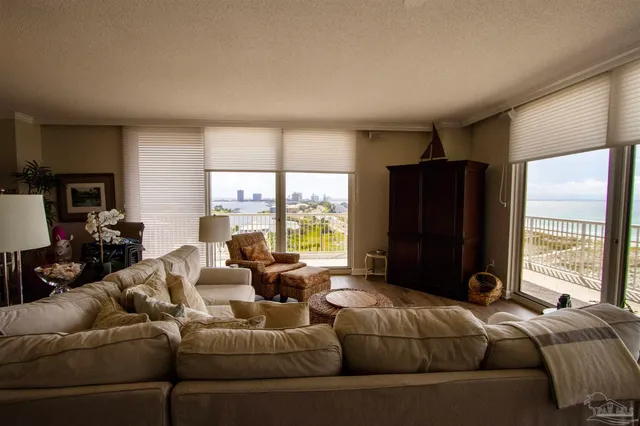 a living room with furniture windows and a flat screen tv