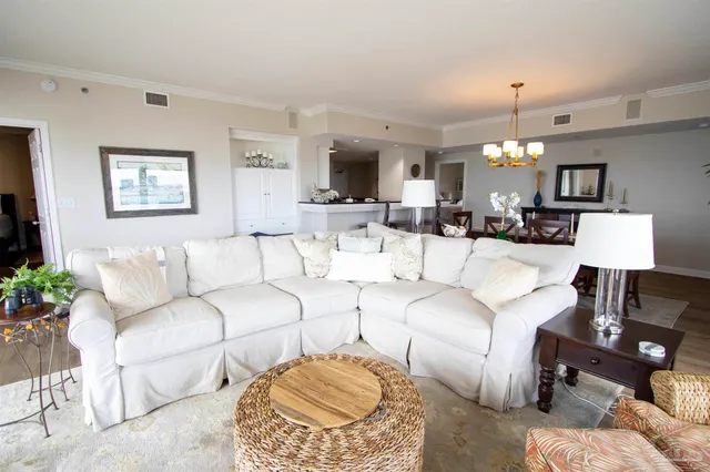 a living room with furniture a lamp and a chandelier