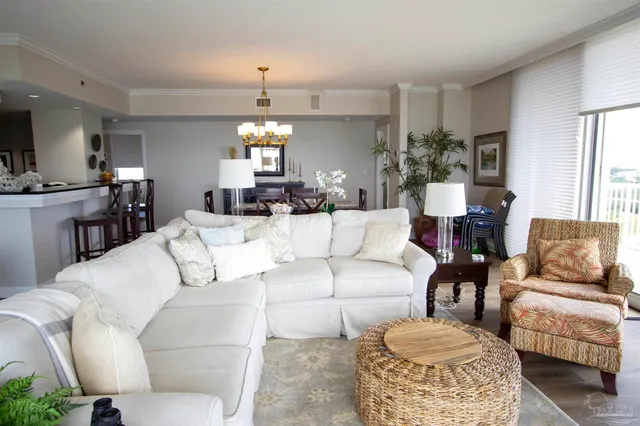 a living room with furniture and a chandelier