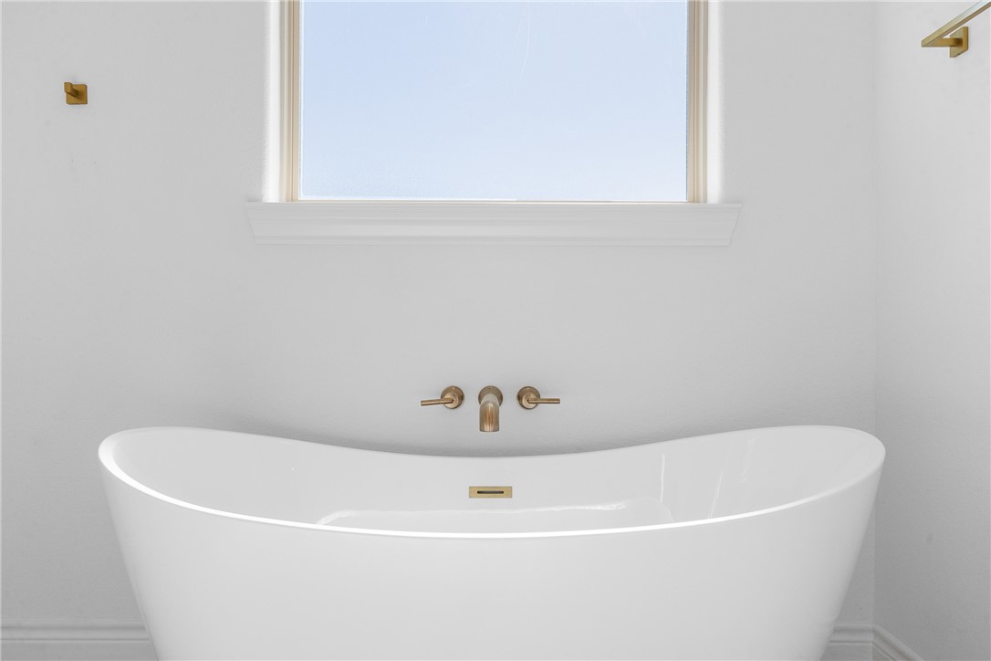 6524 Agave Court Bryan, TX 77808 - Photo 32 of 43 a white bath tub sitting in a bathroom