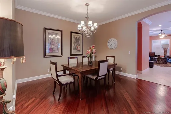 a large kitchen with kitchen island granite countertop a table chairs sink and cabinets