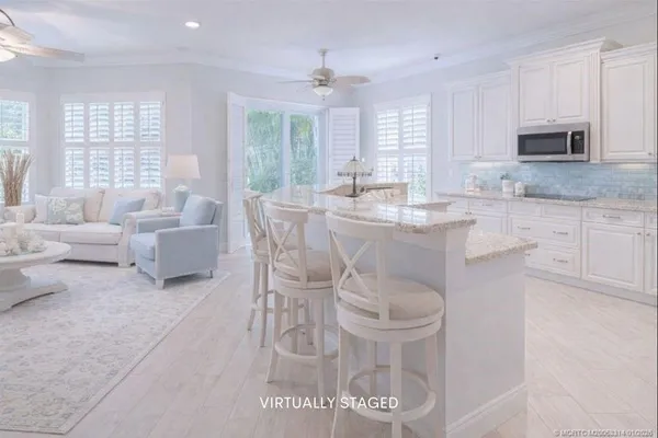 a kitchen with stainless steel appliances granite countertop a stove a sink dishwasher a microwave oven with granite countertops and cabinets