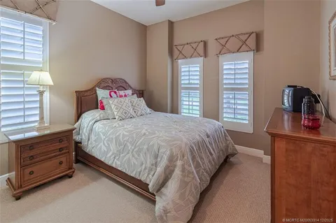 an aerial view of residential houses with outdoor space and ocean view