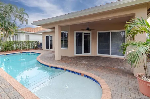 a front view of house with yard and trees in the background
