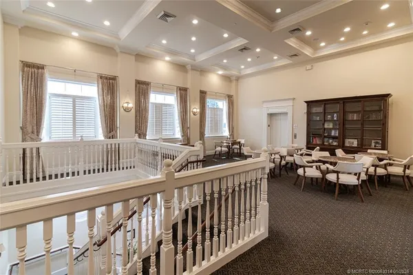 a lobby with furniture and large windows