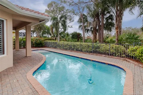 a dining room with furniture and a chandelier
