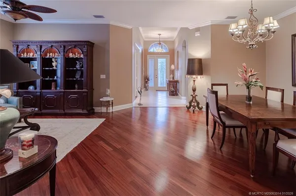 a dining room with furniture and a chandelier