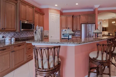 a kitchen with stainless steel appliances granite countertop a stove a sink dishwasher a microwave oven with granite countertops and cabinets