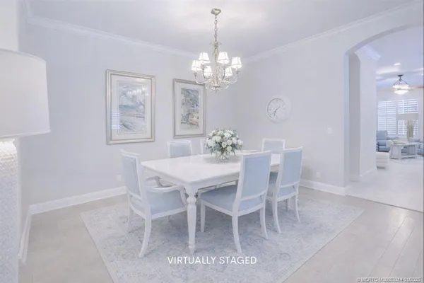 a view of a dining room with furniture wooden floor and a chandelier