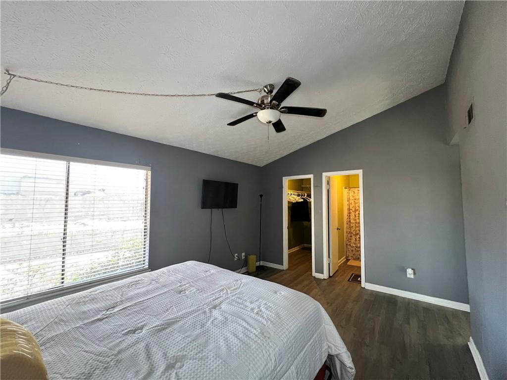 1496 Pine Log Road Northeast, Unit A Conyers, GA 30012 - Photo 11 of 24 a bedroom with a large bed and a large window