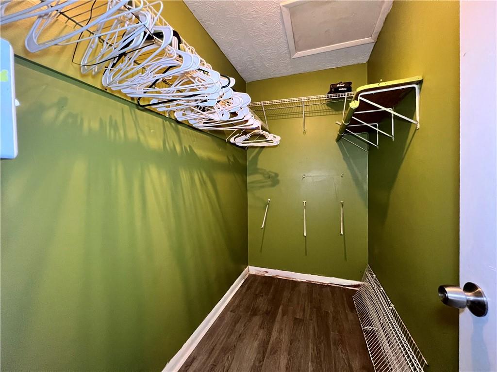 1496 Pine Log Road Northeast, Unit A Conyers, GA 30012 - Photo 12 of 24 a view of walk in closet with clothes