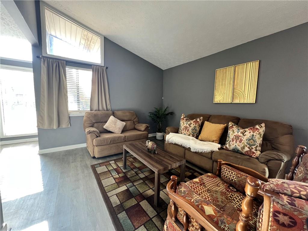 1496 Pine Log Road Northeast, Unit A Conyers, GA 30012 - Photo 14 of 24 a living room with furniture and a large window